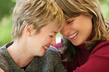 Two women foreheads touching