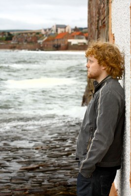 Young man standing on shore